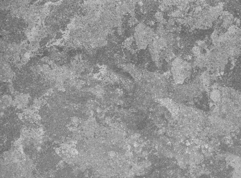 Close-up of a gray cement wall with rough, textured surface ideal for backgrounds.